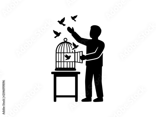 Silhouette of person releasing birds from a cage for freedom concept