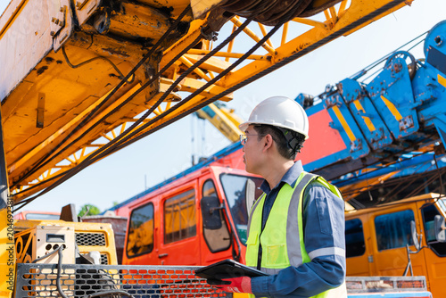 Photos Engineer inspecting crane machinery outdoor construction site