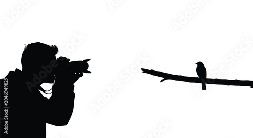 Photography theme silhouette of man taking picture of bird on branch