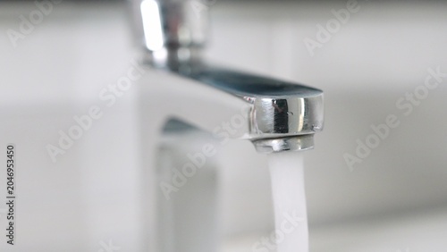 Schilderij op canvas Continuous water flow from an unattended tap symbolizes resource depletion, calling for a shift to conservation practices and eco-friendly living to protect our planet’s precious water supply