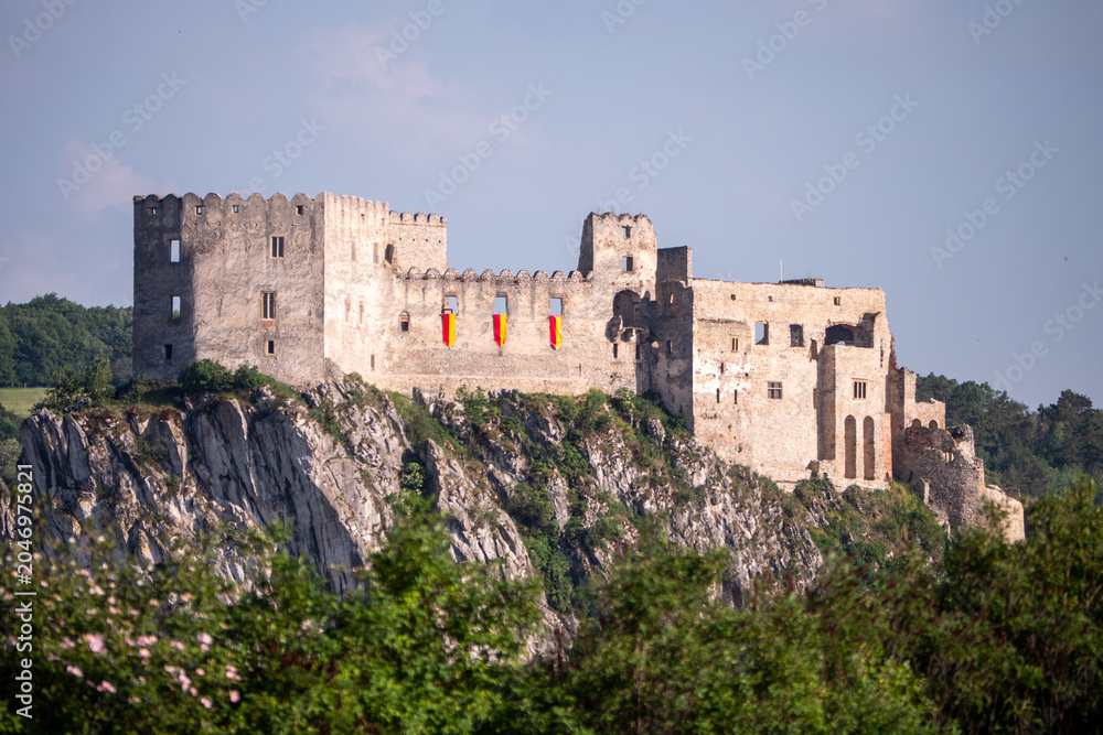 Fototapeta premium Beckov Castle ruins perched on a limestone cliff above the Váh Valley in Slovakia. Historic medieval fortress, landmark and popular travel destination surrounded by nature.