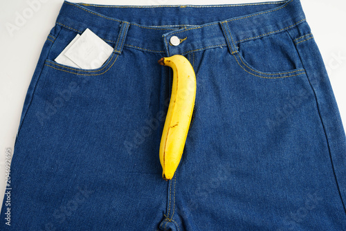 Bild auf Leinwand Banana with measuring tape on jean trousers, penis health.