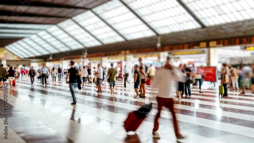Timelapse of anonymous blurred people walking in a busy train station concourse