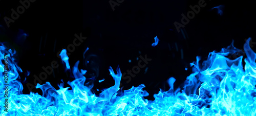 Canvas Print Blue flames blazing against a black background