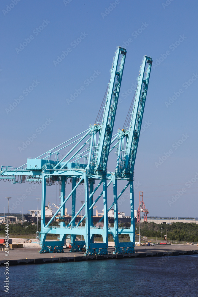 Obraz premium Massive Industrial Port Gantry Cranes at Shipping Container Terminal
