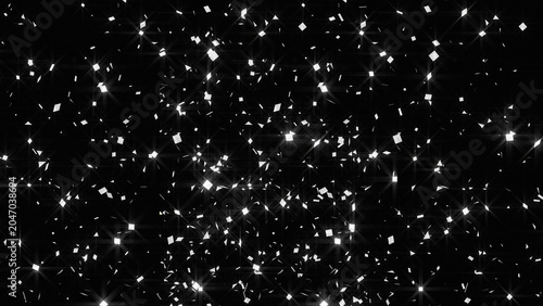 Glittering silver confetti falling on black background, shimmering metallic sparkles for celebration, festive glowing star dust texture