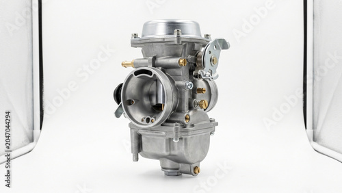 Detailed metallic carburetor isolated on transparent background with studio lighting