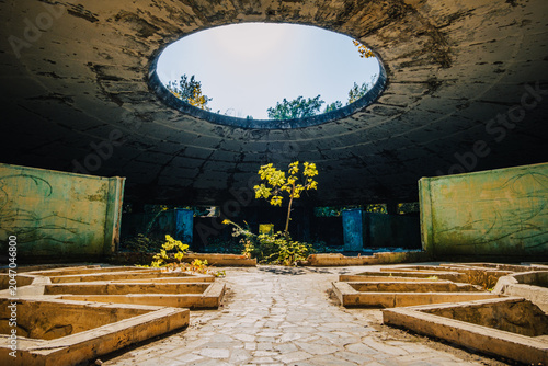 Interior of abandoned Bathhouse #8 in Tskaltubo, Georgia, showcasing a striking skylight and decaying Soviet spa architecture.