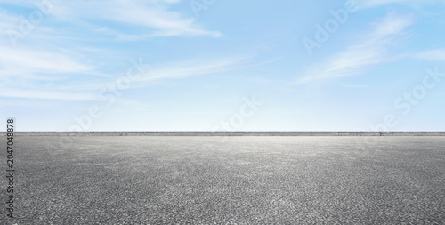 Quadro su tela Empty asphalt road platform with clear blue sky background, open concrete street racetrack mockup with copy space