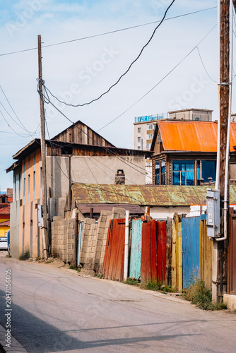 Residential street with colorful fences in Bayangol District, Ulaanbaatar, Mongolia, reflecting everyday urban life.
