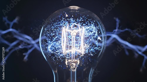 Glowing electrical plasma discharge inside a glass light bulb on a dark background electricity energy glow science