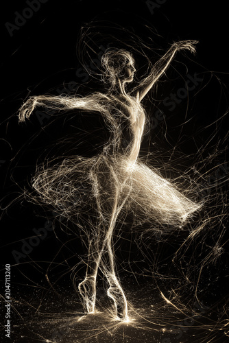 Abstract drawing of a ballerina with light scratches around her. Ballerina dancing with a lot of energy on a black background. Light sparkles around a dancer