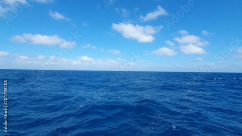 various shapes of clouds in the sky above the choppy sea