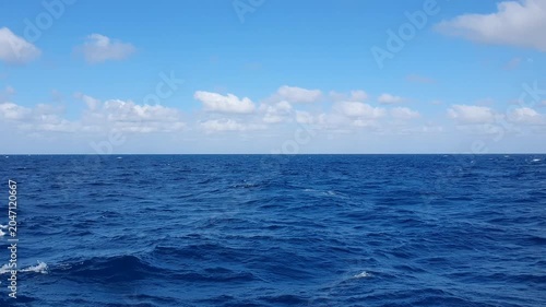 various shapes of clouds in the sky above the choppy sea