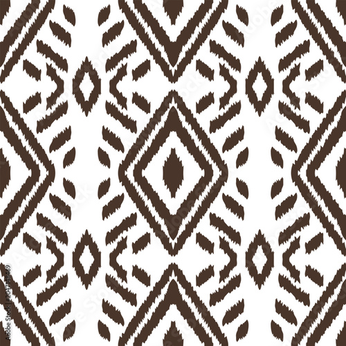 Brown and white ikat seamless pattern, traditional ethnic geometric background