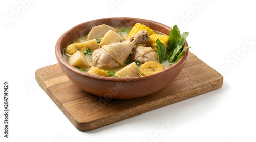 Traditional Panamanian Sancocho chicken soup with root vegetables in a bowl, isolated on white background