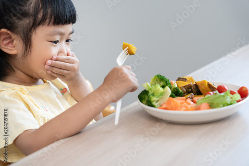 Fotografie Children cover mouth no eat vegetables, bitter taste, peculiar smell, unattracti