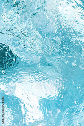 Clear water ripples in a serene pool reflecting sunlight on a bright day