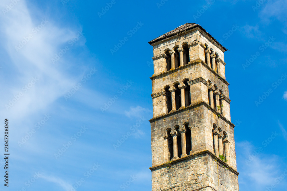 Obraz premium Low angle view of historical St Luke bell tower and medieval church stone walls in Jajce, Bosnia and Herzegovina