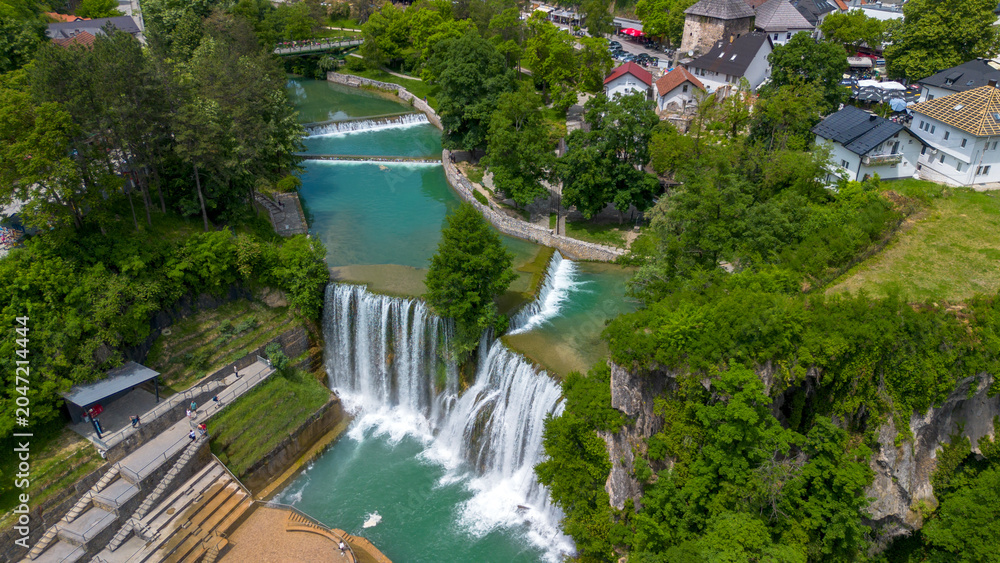 Fototapeta premium Aerial panoramic view of beautiful Pliva waterfall and medieval old town castle in Jajce, Bosnia and Herzegovina