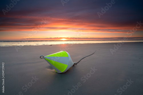 beach of Sankt Peter Ording with a big yellow buoy while low tide