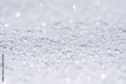 Sparkling Snow Surface Background with Copy Space, Beautiful Glistering Ice Crystals with Soft Bokeh in Bright Sunshine, Abstract Winter Nature Texture