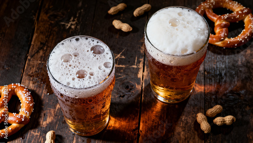 Moody top down flat lay of freezing cold craft beer glasses on dark wooden pub table