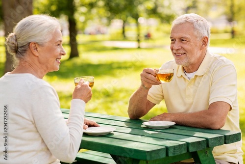 Elderly couple enjoying tea outdoors