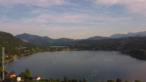Aerial sunset view of Avigliana, Italy, Piedmont , Turin,Italy A beautiful town with a medieval castle and red-roofed houses, surrounded by the green hills of Susa and trees on a sunny day.