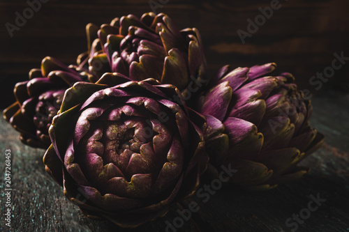 Fresh Purple Artichokes on Rustic Wooden Background