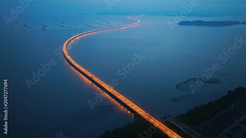 Aerial view of highway light of Penang Second Bridge with dramatic twilight sunset sky background