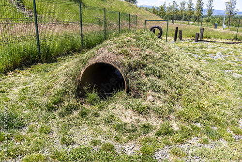 Concrete Tunnel Obstacle Embedded in Grassy Agility Dog Park