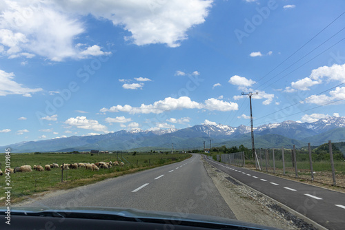 First Person Road Trip Driving View Towards Majestic Snowy Mountains