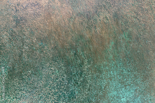 Fotografie Brushed copper surface texture with green verdigris spots background