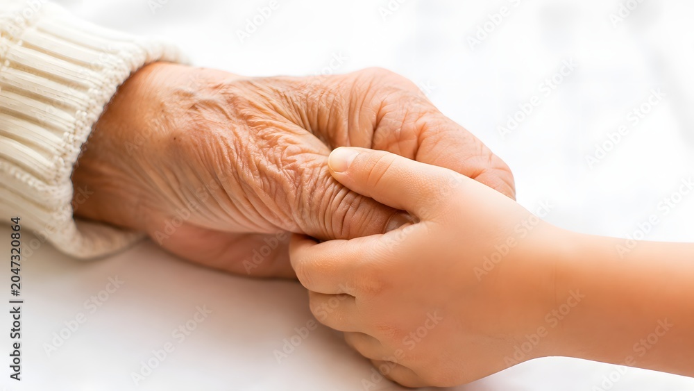 Naklejka premium Gentle connection between an elderly hand and a child's hand, symbolizing care and legacy