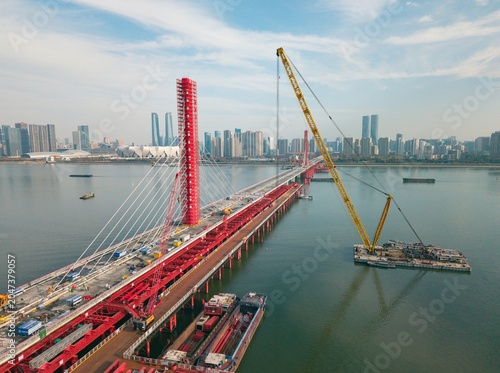 Fotografia Aerial view of cranes and construction equipment are working to dismantle an old cable stayed bridge
