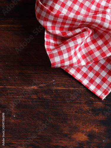 On a wooden background, food, checkered towel, napkin