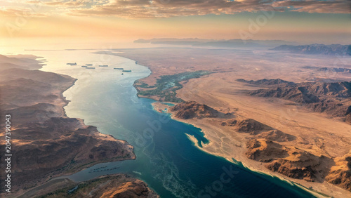 Aerial view of the strait of hormuz at sunrise with shipping traffic