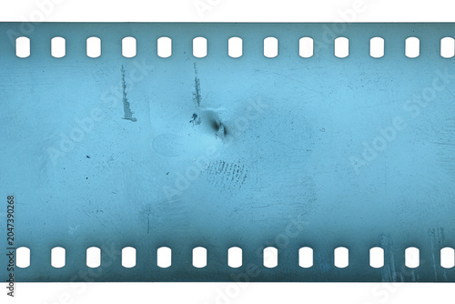 Dusty and grungy 35mm film texture or surface. Perforated scratched camera film isolated on white background.