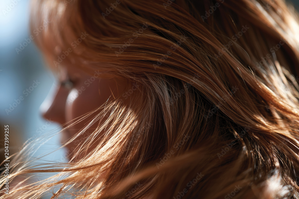 Fototapeta premium A close-up shot of stunning hair cascading in the light showcases the intricate details and luster of the hair, highlighting quality and care in personal grooming.