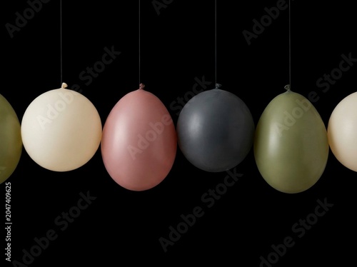 Colorful Easter eggs hanging in row.