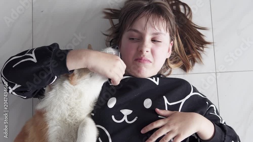 A playful Pembroke Welsh Corgi puppy happily spends time with a child at home, displaying friendliness, fun, and warmth in a cozy home environment. Pet concept.