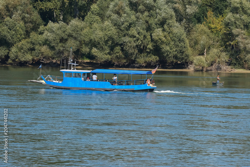 Kleines blaues Ausflugsboot auf einem Fluß