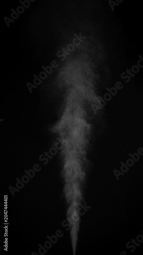 Hot Steam Plume. Slow-motion of hot steam powerfully rising from below, forming a tall turbulent column that expands, gradually dissipates into fine sparkling particles against deep black background.