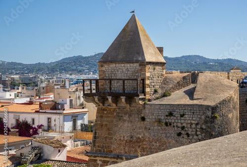 Bild auf Leinwand Ibiza, Spain: Ancient stone fortification wall and bastion gate in Dalt Vila old town under a clear blue sky, a historic UNESCO World Heritage site