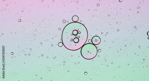 Abstract oil bubbles on water surface, pastel pink and green liquid texture, macro photography of floating spheres and organic shapes