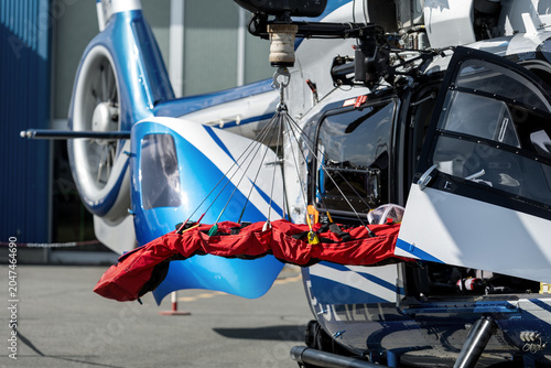 Φωτογραφία Rescue helicopter stands ready evacuation stretcher suspended open cabin door airfield