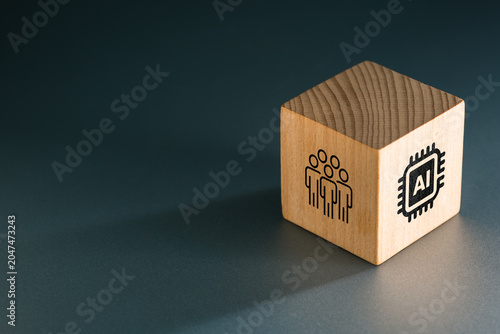 Wooden cube showing people and AI icons on different sides  symbolizing human-centered artificial intelligence  collaboration  governance  and the evolving relationship between technology and people