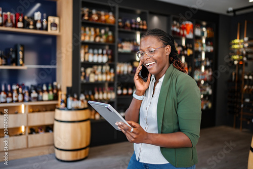 Quadro su tela Black woman small business owner managing liquor store operations