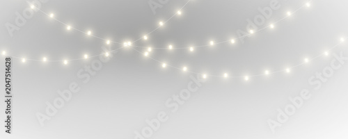 Konstfotografi Twinkling Christmas bulbs hang on a delicate wire strand